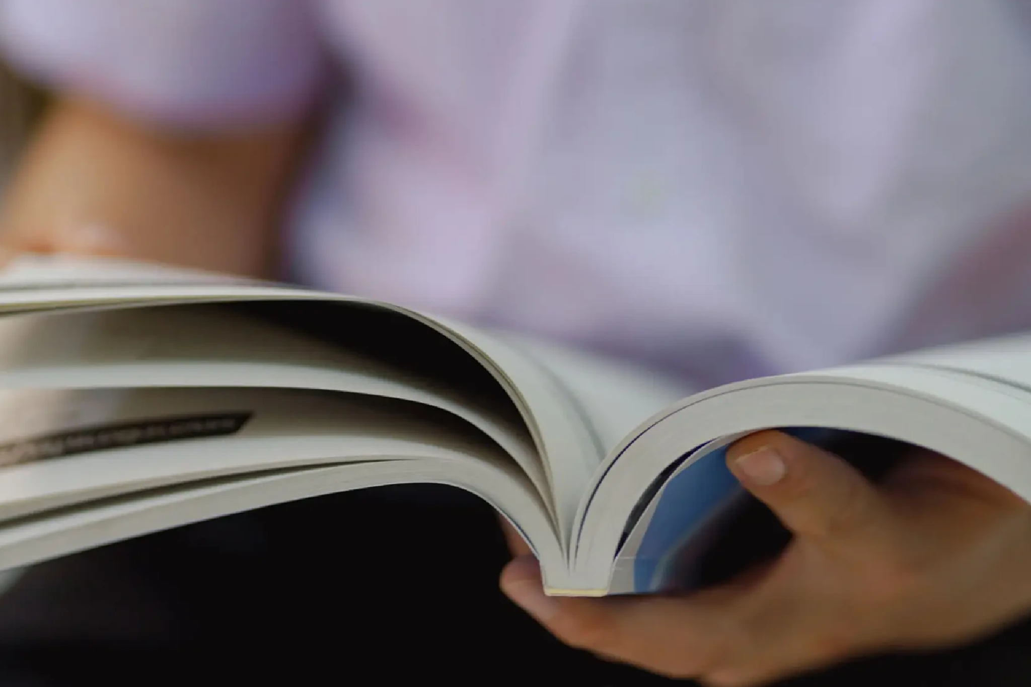 A person flipping through a book's pages.